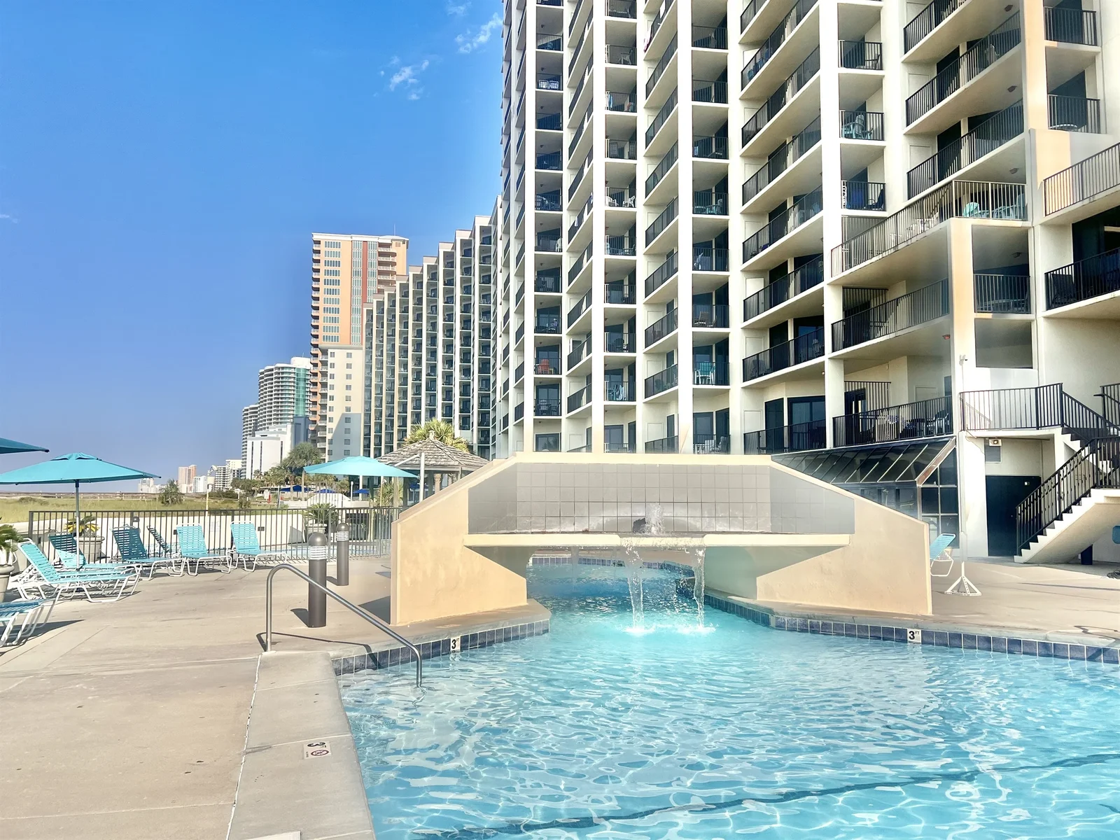 Outdoor pool and waterfall at Phoenix VII in Orange Beach
