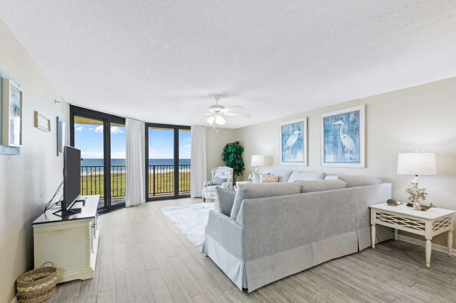 Gulf front living room with floor to ceiling windows at Phoenix VII 7303