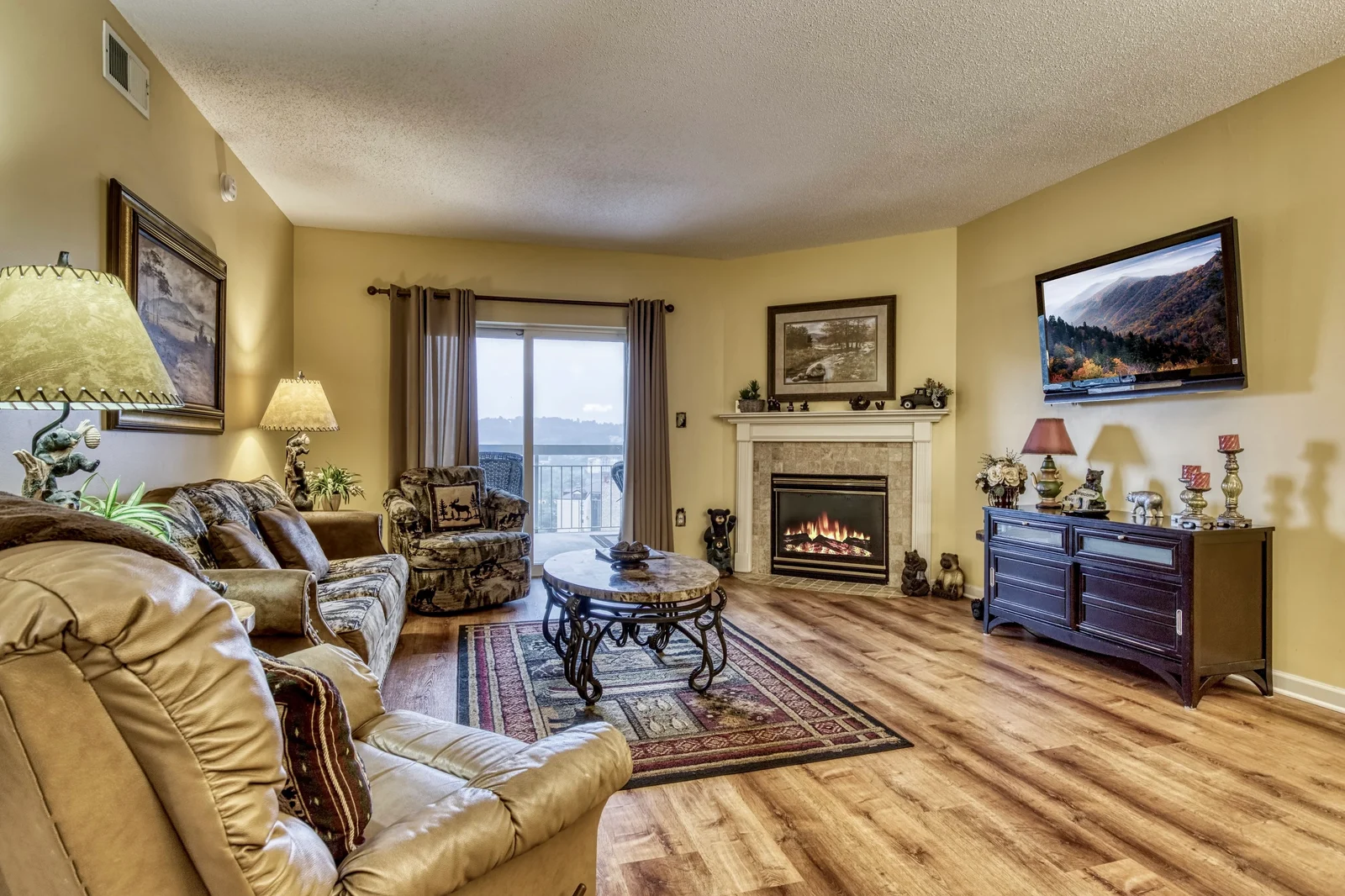 Whispering Pines condo living room with fireplace and balcony